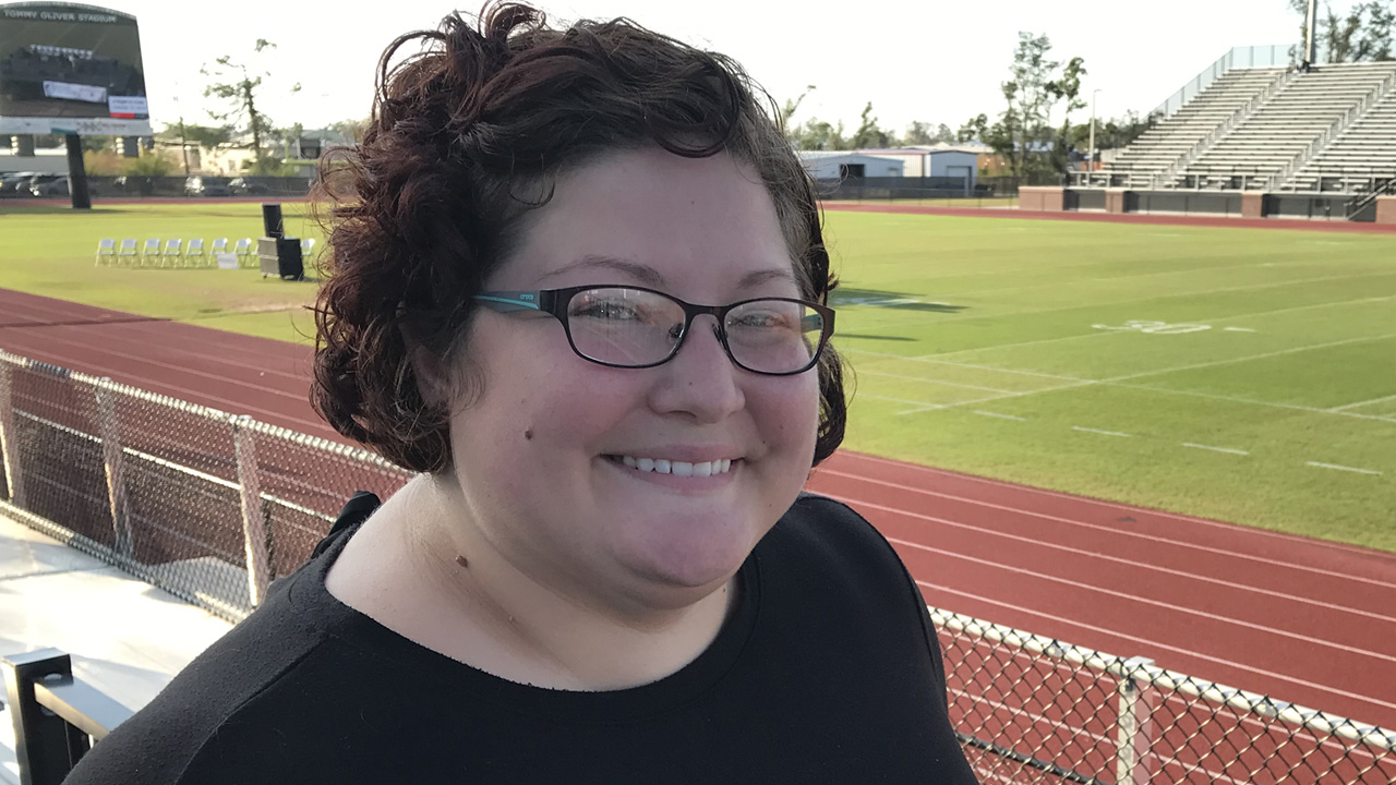 Lindsay, wearing glasses, smiling