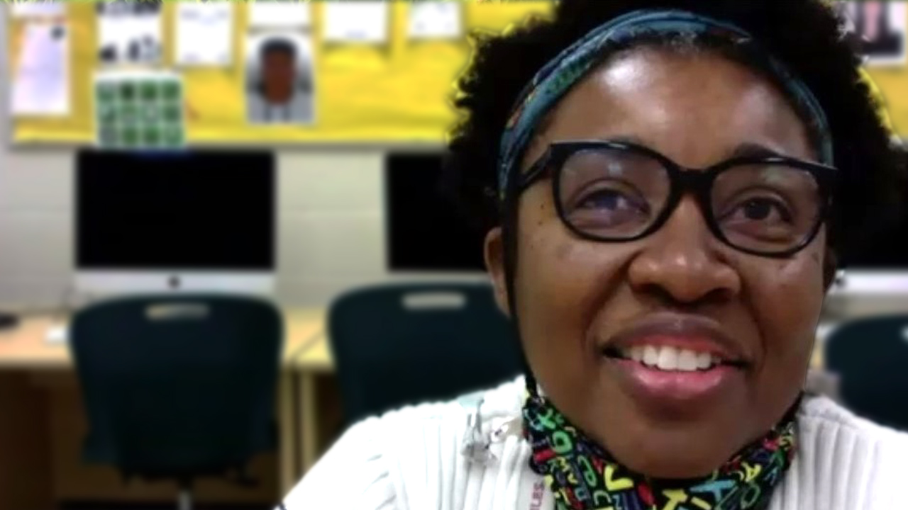 Woman in white sweater with glasses