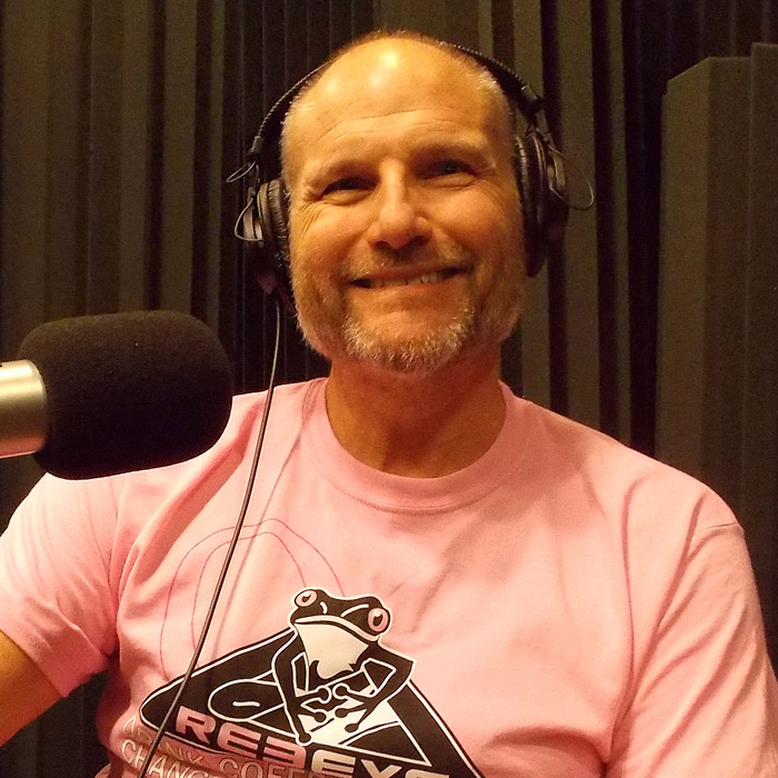 Mark McNees sitting in WFSU's radio studio in front of the mic