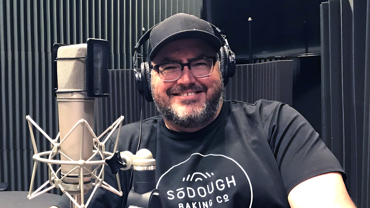 Matt Thompson in sitting front of the microphone