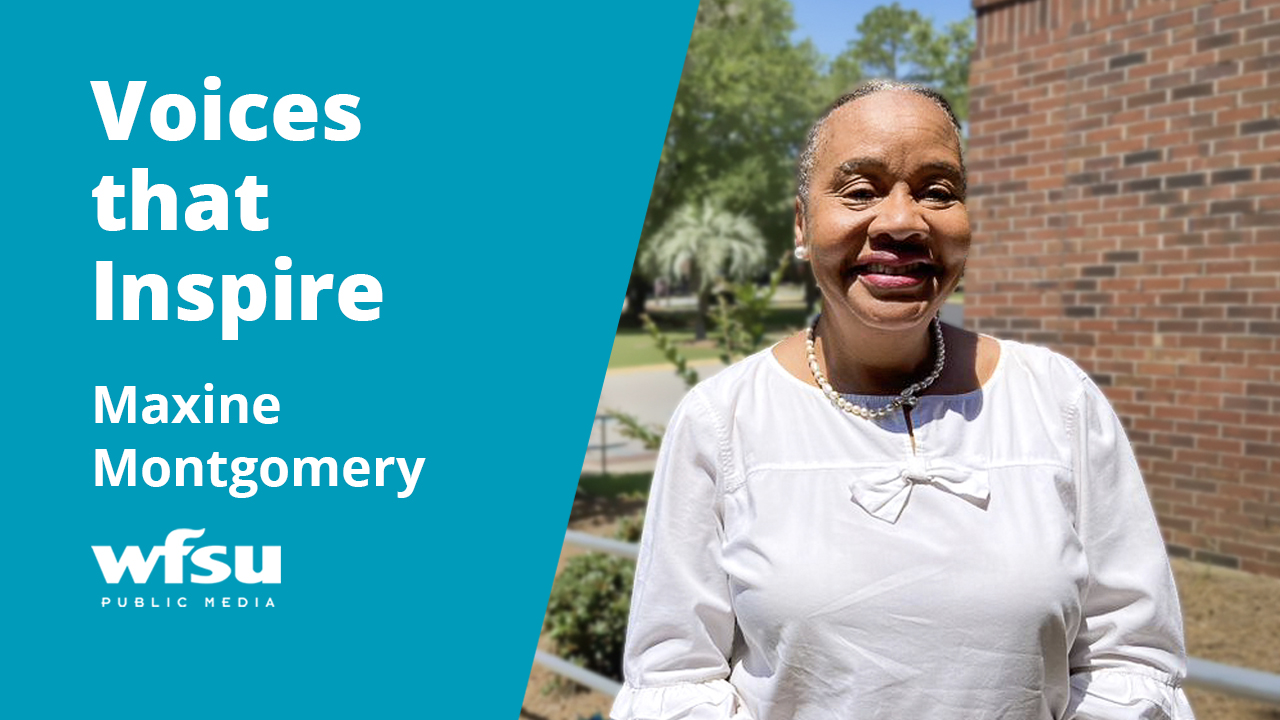 A smiling woman stands outside