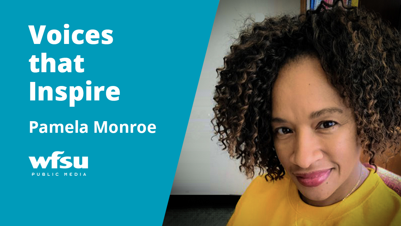 A smiling woman in a yellow shirt stares forward.