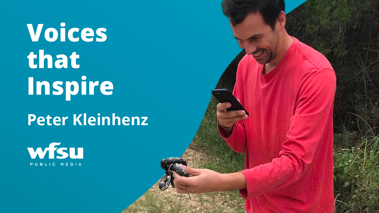 Man in teal shirt outdoors