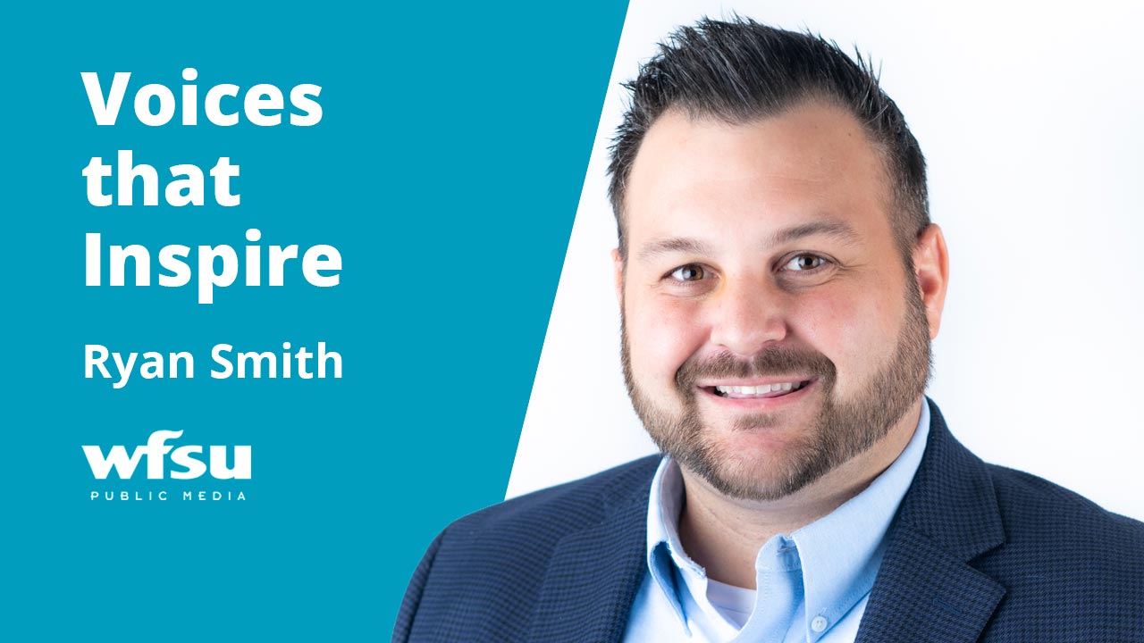 Bearded man smiling in blue suit