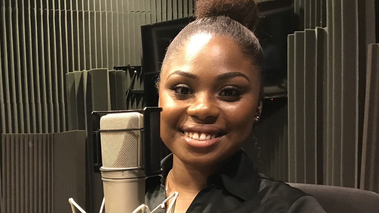 Shaqualyn Shedrick smiling by the microphone