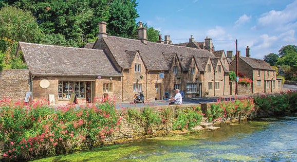 Old cobble brick building with a river in front of it