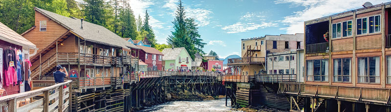 wooden western buildings and a bridge over a river