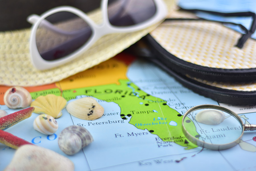 florida map with sunglasses and flip flops