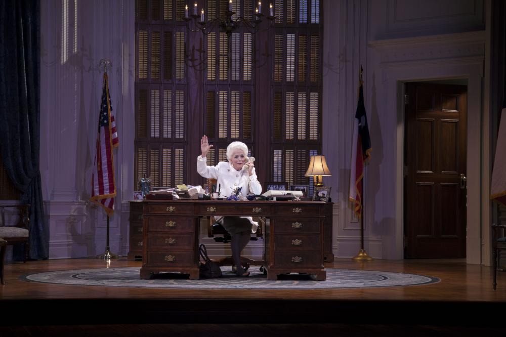 Woman sitting at a desk (On stage)