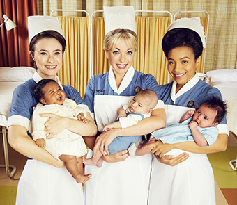 Three midwifes holding little babies