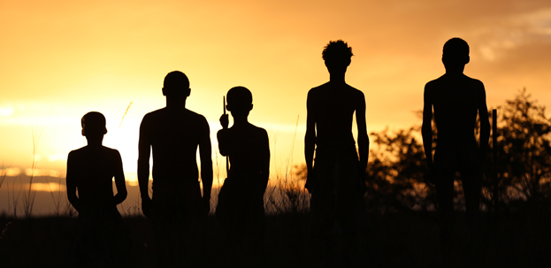 Silhouette of a human family infront of the sunrise