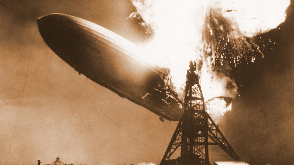 Hindenberg engulfed in a fiery explosion coming out of the rear of the vessel