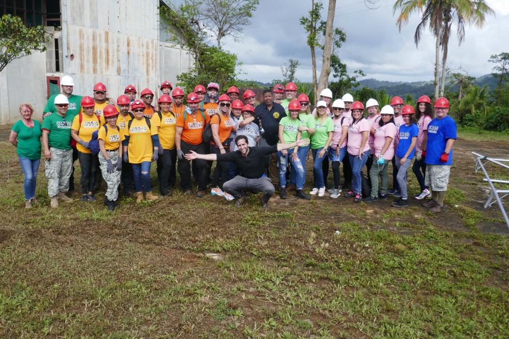 A large group of people with construction hats on