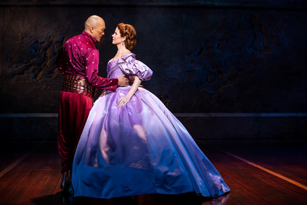 Man and woman singing on stage