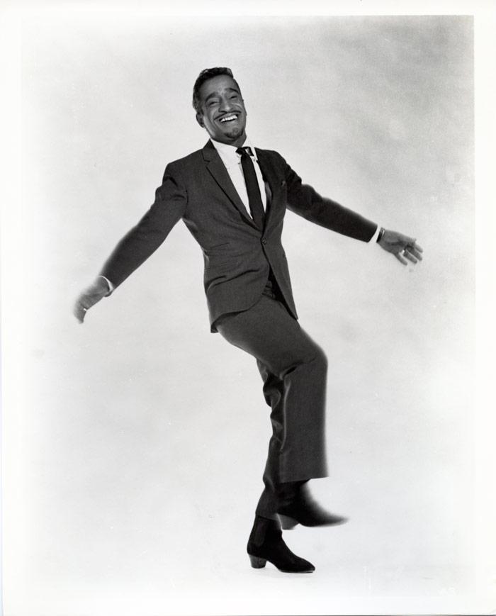 black and white photo of sammy davis junior dancing with arms held out
