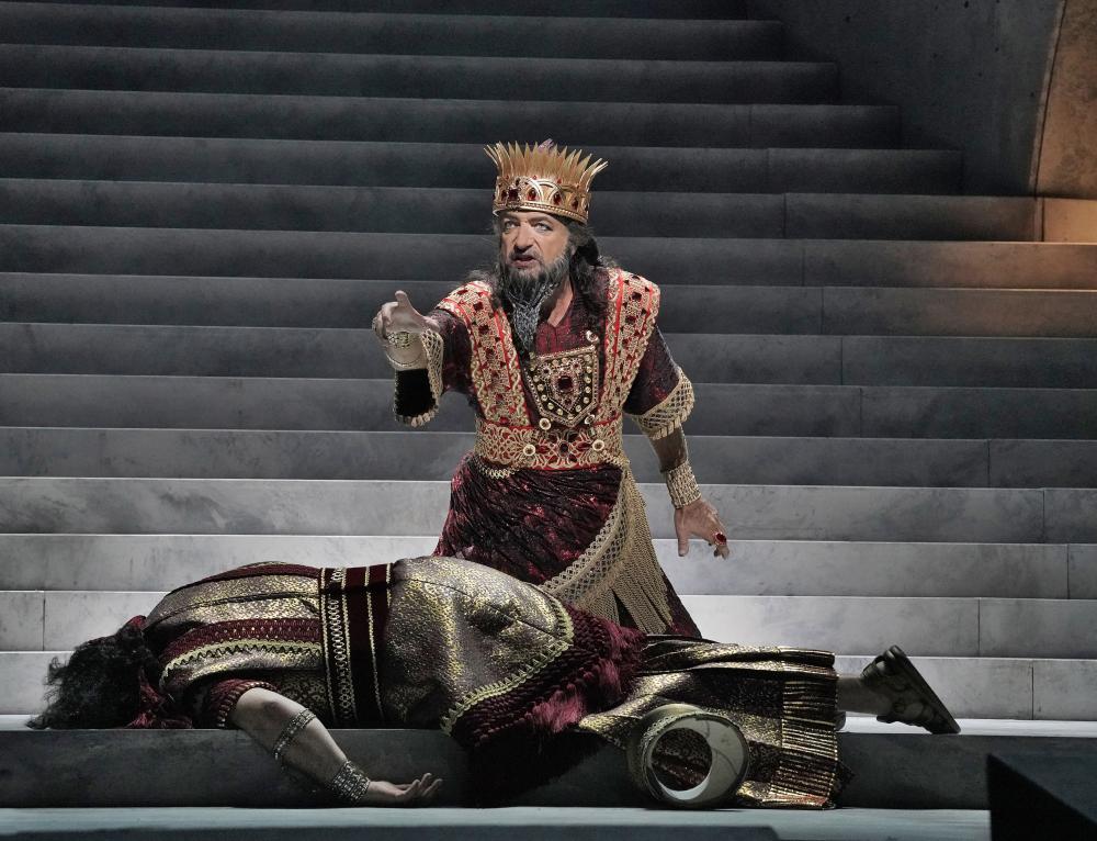 A king standing over a dead body