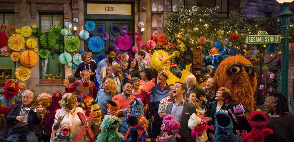 A colorful crowd of people and muppets