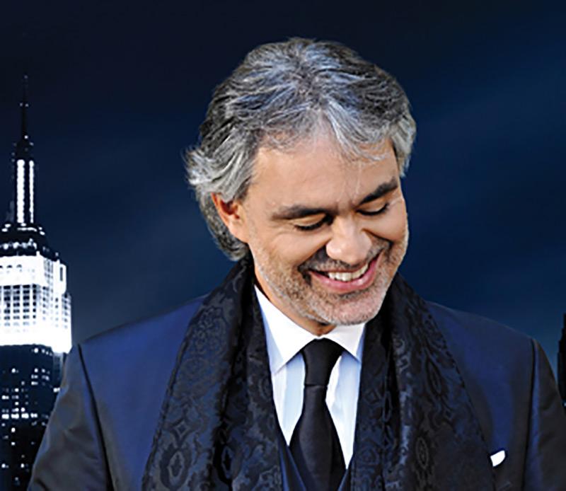 andrea bocelli in a blue suit smiling