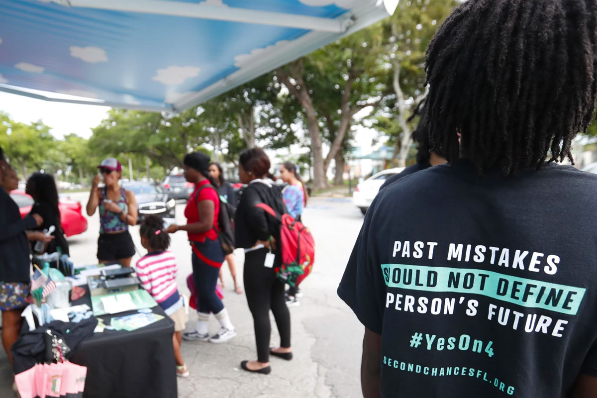 woman wearing a t-shirt which reads: past mistakes should not define a person's future #yeson4