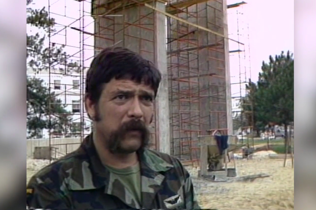 man standing in front of memorial construction site