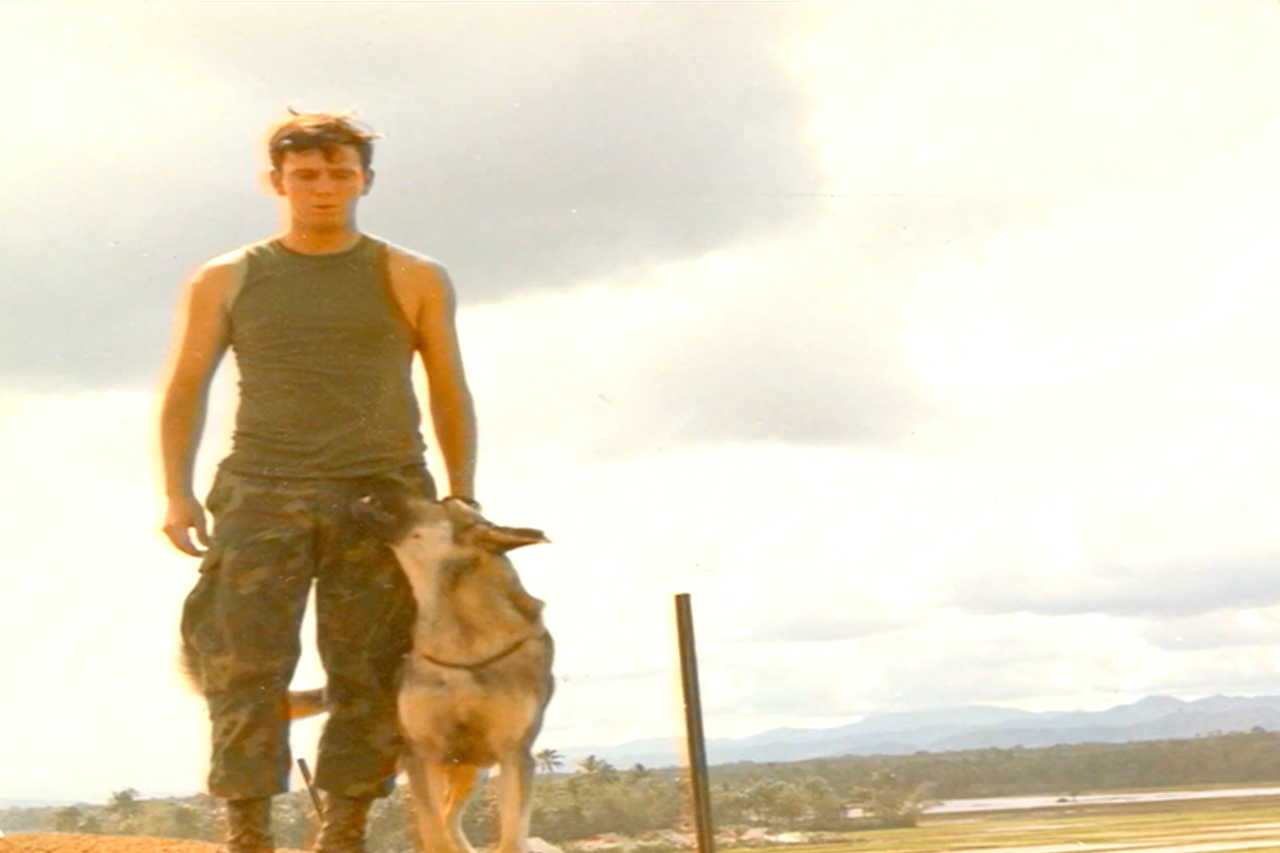 war dog with uniformed master